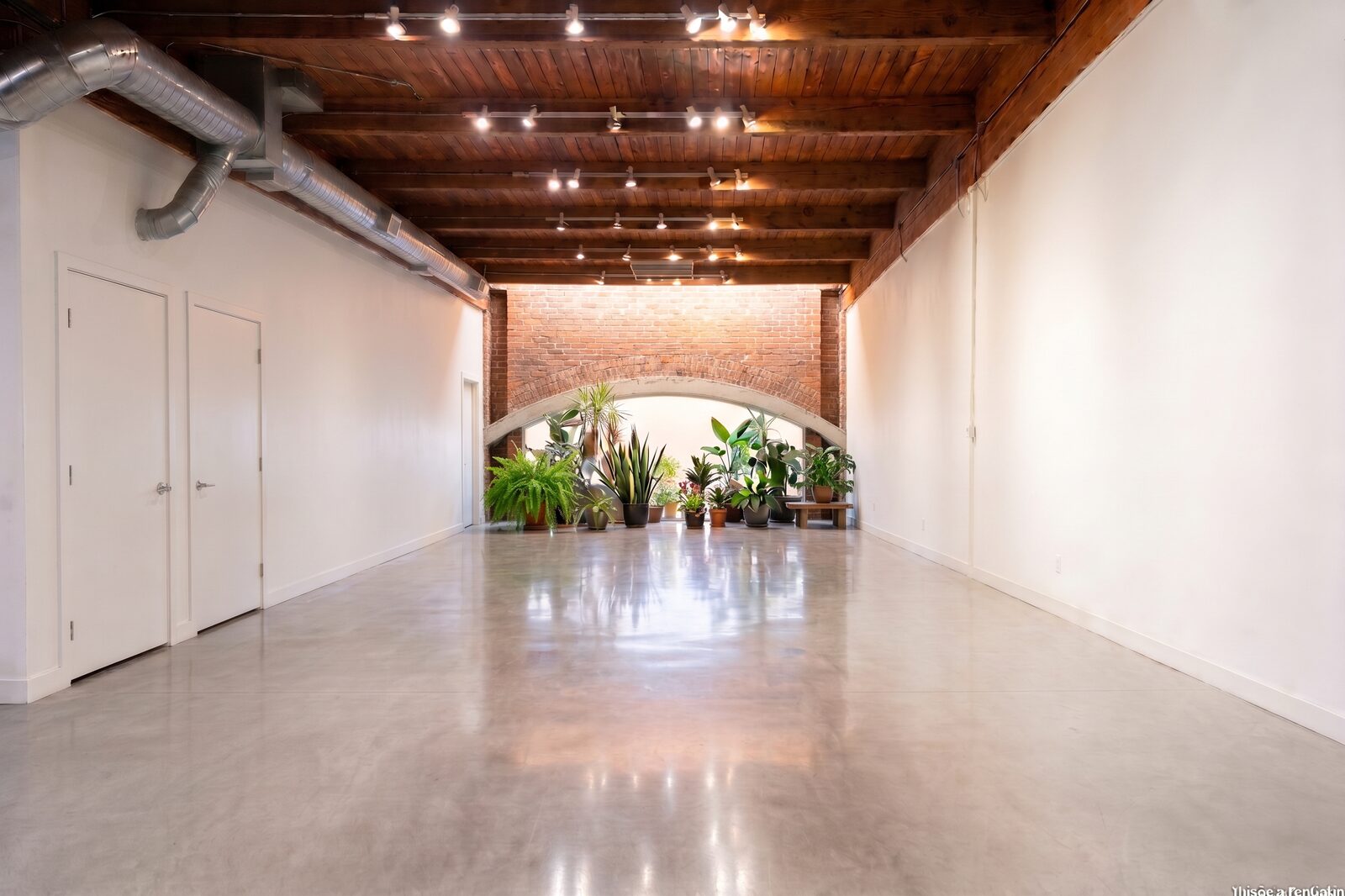 Concept rendering of Unit 210's arched brick breezeway styled as a gallery walkway with plantings