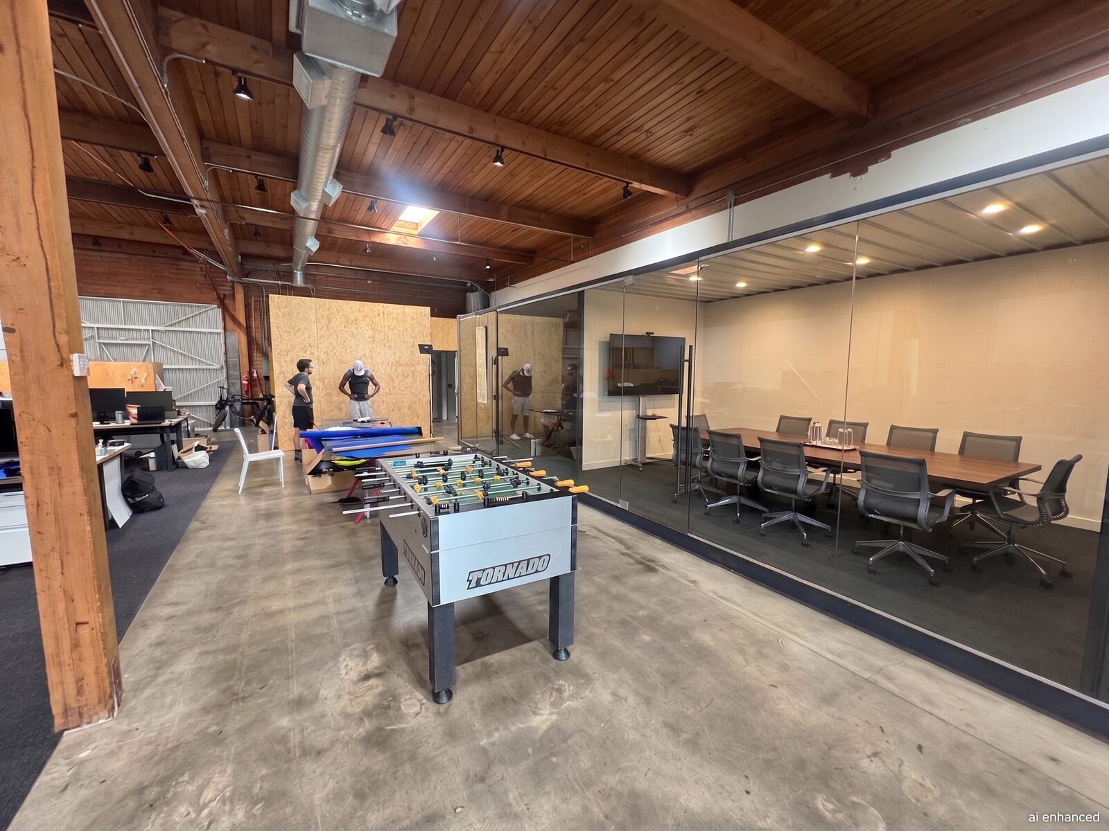 Global Lifestyle's industrial design studio at 216 East Cota Street, with an open workspace and glass-walled conference room under exposed wood beams