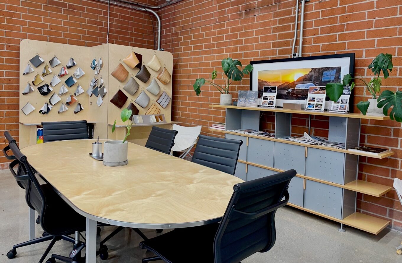 Bowlus design studio at 528 Santa Barbara Street, with a materials and finish swatch wall against exposed brick