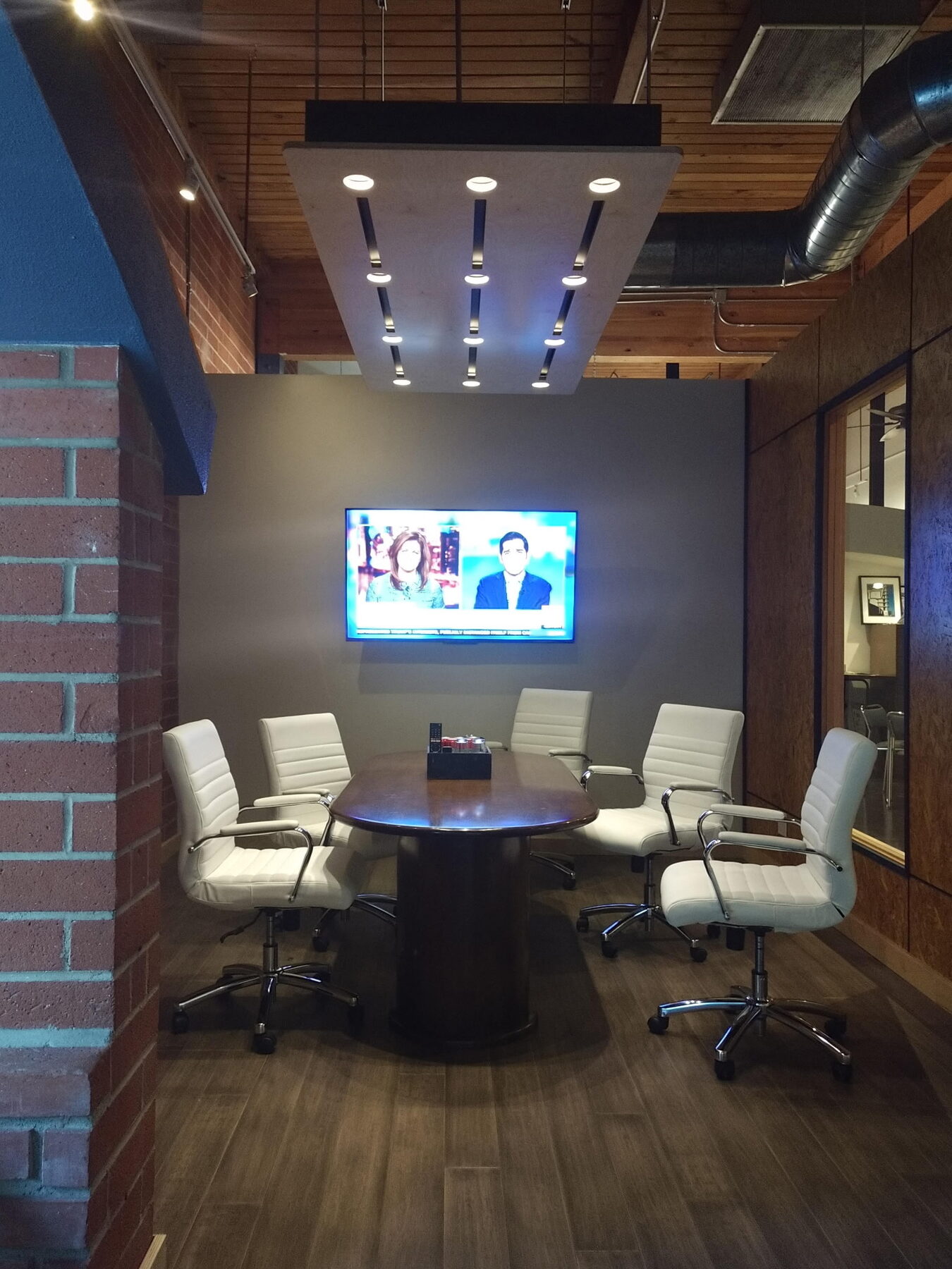 Wilco Group's conference room with a wall-mounted TV and seating for six
