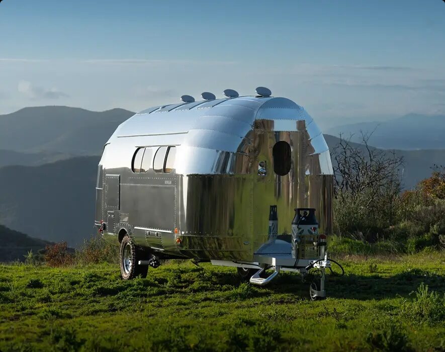 A Bowlus travel trailer parked on a hillside overlooking the Santa Barbara backcountry