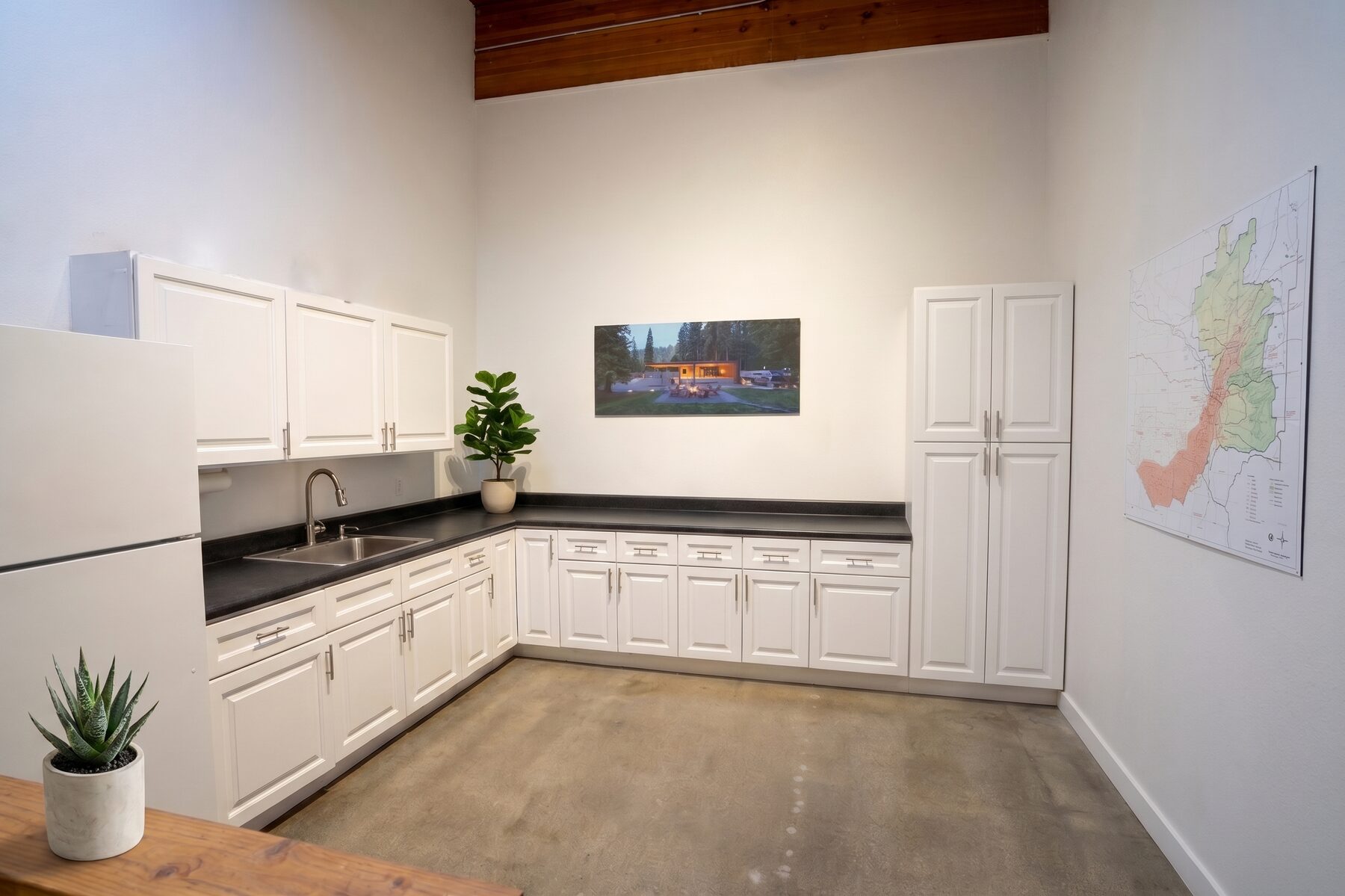 Wet pantry with white cabinetry, sink and counter in Unit 210